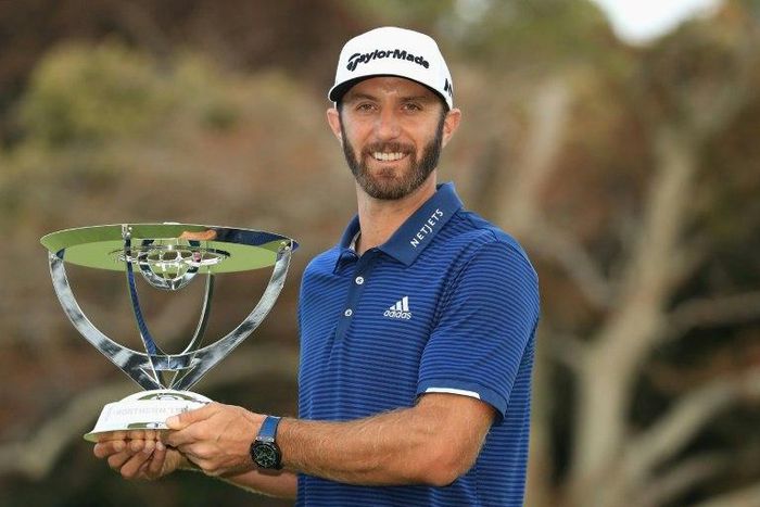Dustin Johnson of the US poses with the trophy after putting for birdie on the 18th green to defeat compatriot Jordan Spieth in a playoff to win The Northern Trust, at Glen Oaks Club in Westbury, New York, on August 27, 2017