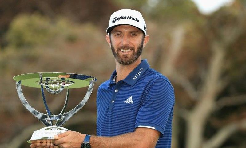 Dustin Johnson of the US poses with the trophy after putting for birdie on the 18th green to defeat compatriot Jordan Spieth in a playoff to win The Northern Trust, at Glen Oaks Club in Westbury, New York, on August 27, 2017