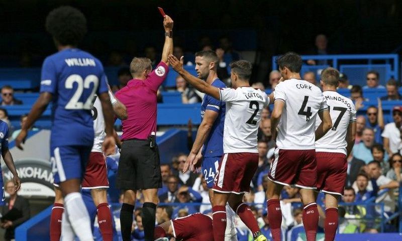 Chelsea's Gary Cahill (C) is shown a red card by referee Craig Pawson after a foul on Burnley's Steven Defour during their English Premier League match, at Stamford Bridge in London, on August 12, 2017