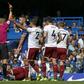 Chelsea's Gary Cahill (C) is shown a red card by referee Craig Pawson after a foul on Burnley's Steven Defour during their English Premier League match, at Stamford Bridge in London, on August 12, 2017