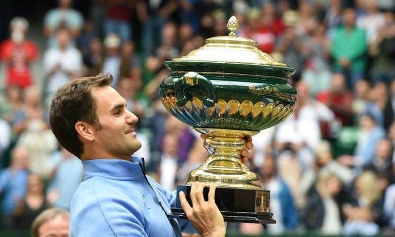 Roger Federer poses with his trophy after winning his final match against Alexander Zverev, at the Gerry Weber Open tennis tournament in Halle, western Germany, on June 25, 2017
