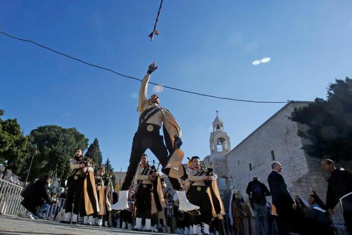 Palestinian bagpipers perform on Manger Square in Bethlehem, in the occupied West Bank, on December 24, 2018