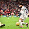 Liverpool's Egyptian midfielder Mohamed Salah (R) takes the ball around Bournemouth's Bosnian-Herzegovinian goalkeeper Asmir Begovic (L0 in the build-up to scoring his third goal, Liverpool's fourth during the English Premier League football match betw...