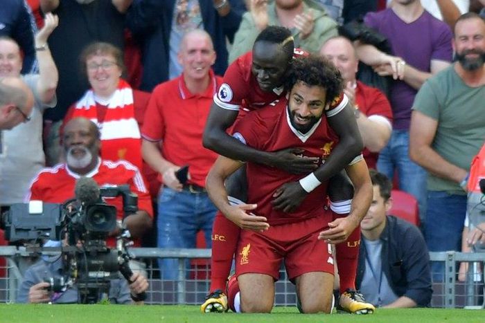 Liverpool's Mohamed Salah (R) celebrates with Sadio Mane after scoring their third goal during their match against Arsenal Liverpool, north west England on August 27