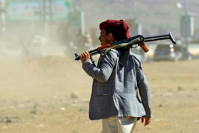 An Yemeni man holds an AK-47 as people gather in the capital Sanaa to show their support to the Shiite Huthi movement against the Saudi-led intervention, on December 19, 2018