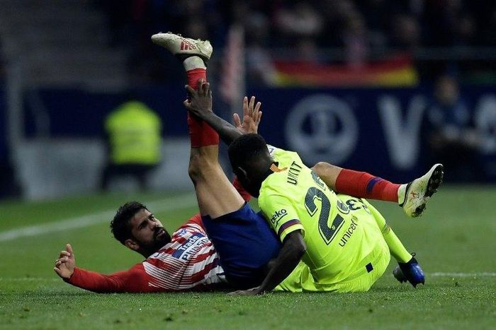 Atletico Madrid forward Diego Costa in a tangle with Barcelona's Samuel Umtiti