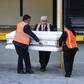 Employees of a funeral home carry a coffin with the repatriated remains of seven-year-old Guatemalan migrant girl Jakelin Caal