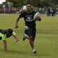 An inmate with the El Tocoron rugby team (R) eludes a prisoner from the rival Centinelas team during the Penitentiary Rugby Tournament in La Victoria, Aragua State, Venezuela