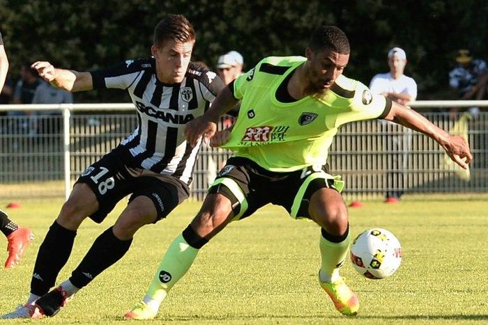 English forward Lewis Grabban (R), then of Bournemouth, is tackled by Angers midfielder Baptiste Santamaria during an international friendly in Saumur, northwestern France on August 6, 2016