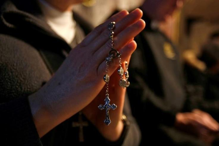 Christian pilgrims pray inside the grotto where Jesus is believed to have been born at the Church of the Nativity in Bethlehem on December 24, 2018