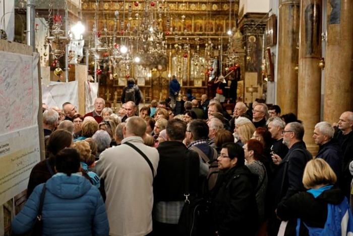 A group of tourists and pilgrims visit the Church of the Nativity, the place where Jesus is said to have been born, in the Biblical West Bank town of Bethlehem