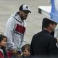 Barcelona player Luis Suarez (C) arrives with his family at the Santa Fe Province airport in Rosario, Argentina for his teammate Lionel Messi's wedding