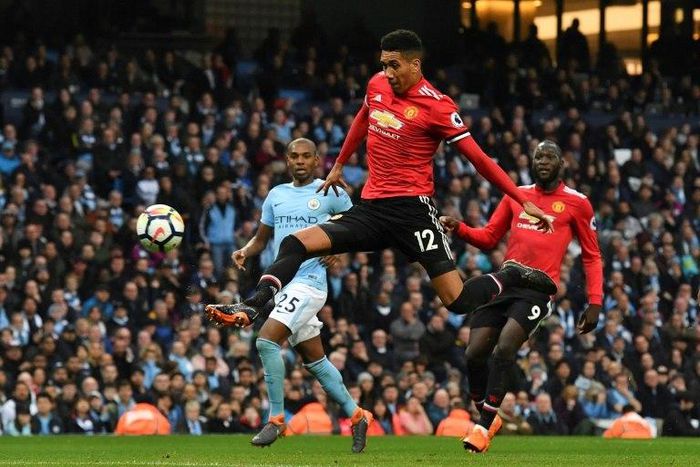 Manchester United defender Chris Smalling (centre) has signed a new contract until 2022