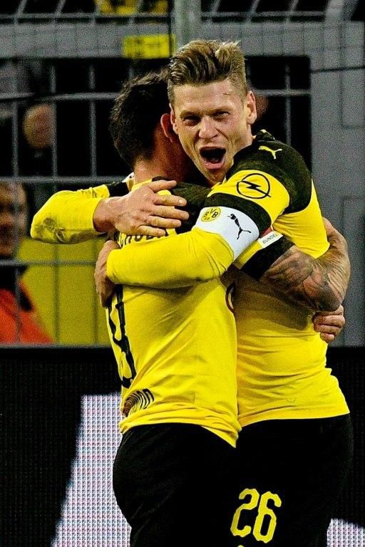 Borussia Dortmund's Polish defender Lukasz Piszczek (R) hugs Spanish forward Paco Alcacer, who scored their second goal in the 2-0 win over Freiburg to become the Bundesliga's top scorer with 10 goals so far.