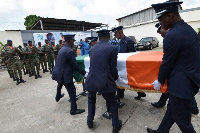 Pallbearers carry the coffin of football star Cheick Tiote during a funeral ceremony on June 18, 2017 in Abidjan
