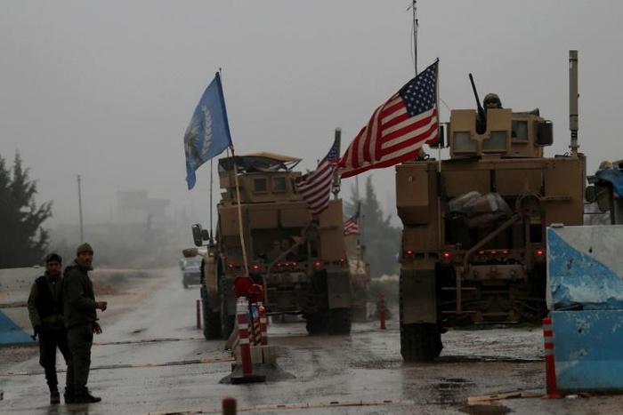A line of US military vehicles head to their base on the outskirts of the northern Syrian city of Manbij on December 30, 2018