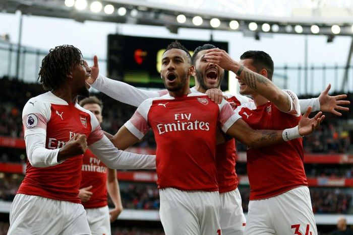 Arsenal players celebrate a goal against Tottenham on December 2, 2018