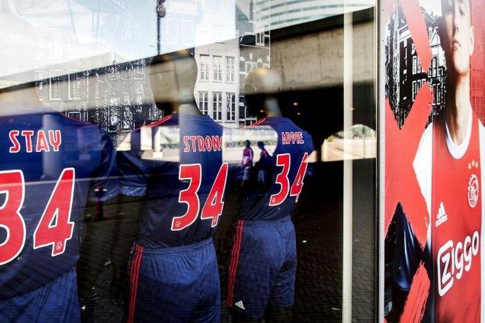 Football jerseys bearing the words, "Stay Strong Appie" and the number 34 to show support to Ajax midfielder Abdelhak Nouri at the Ajax football club store in Amsterdam on July 10, 2017 Nouri was "out of life-threatening danger" but still in intensive ...