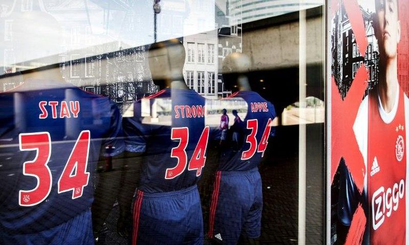 Football jerseys bearing the words, "Stay Strong Appie" and the number 34 to show support to Ajax midfielder Abdelhak Nouri at the Ajax football club store in Amsterdam on July 10, 2017 Nouri was "out of life-threatening danger" but still in intensive ...
