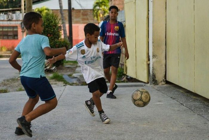 Cuban children play soccer in a street in Havana, where the "beautiful game" is threatening to topple baseball as the island's most popular sport