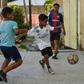 Cuban children play soccer in a street in Havana, where the "beautiful game" is threatening to topple baseball as the island's most popular sport