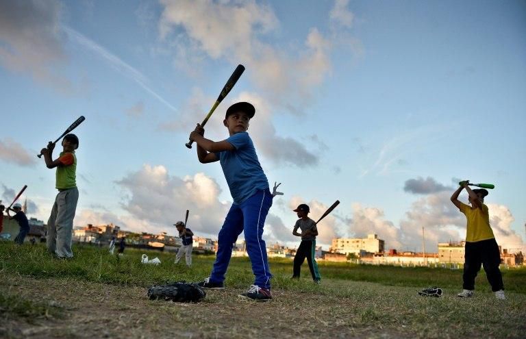 Cuban children swing their bats during baseball practice in Havana