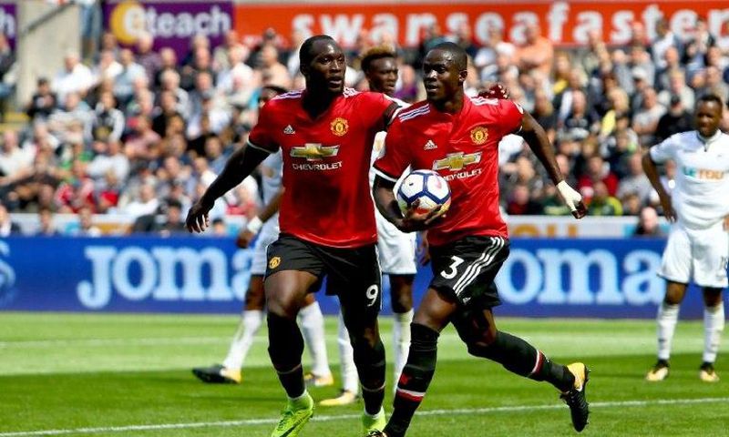 Manchester United's Eric Bailly (R) celebrates with teammate Romelu Lukaku after scoring a goal during their English Premier League match against Swansea City, at The Liberty Stadium in Swansea, south Wales, on August 19, 2017