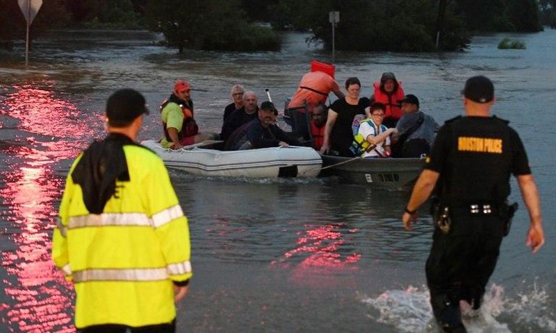 People are rescued from the Omni hotel by boat after Hurricane Harvey caused heavy flooding in Houston