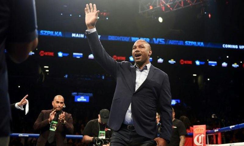 Former heavyweight champion Lennox Lewis (C) waves from the ring at Barclay's Center in Brooklyn, New York, in January 2016