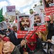 Tunisian women hold up saws and signs saying in Arabic, "No welcome, Tunisians against the visit of the Saudi Crown Prince to Tunisia", during an anti-Saudi Crown Prince protest in Tunis on November 27, 2018