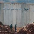 Israeli soldiers stand bye the concrete barrier erected along the border with Lebanon near the northern Israeli town of Metula: a Un investigation said two tunnels dug by Hezbollah stretched beneath the border line and into Israeli territory