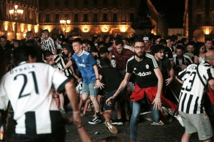 (FILES) This file photo taken on June 04, 2017 shows Juventus' supporters evacuating the Piazza San Carlo after a panic movement in the fanzone where thousands of Juventus fans watched the UEFA Champions League Final football match between Juventus and...