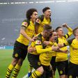 Thomas Delaney (bottom centre) is mobbed by his Dortmund team-mates after scoring against Schalke