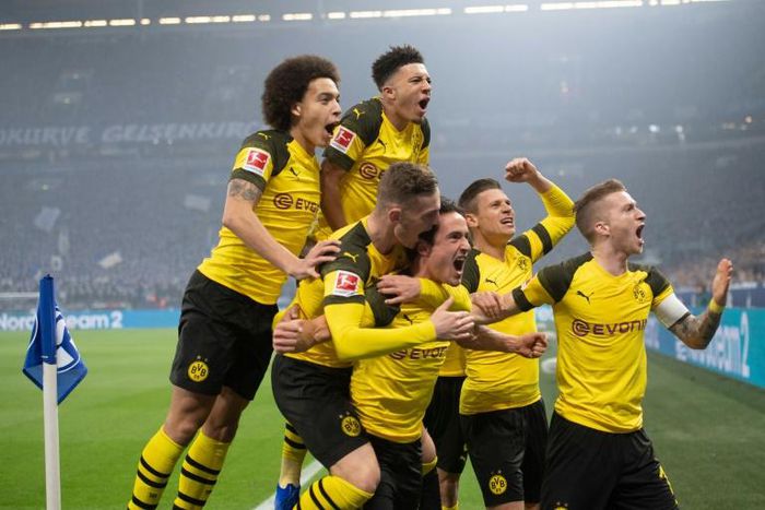 Thomas Delaney (bottom centre) is mobbed by his Dortmund team-mates after scoring against Schalke