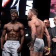 Boxer Floyd Mayweather Jr. (L) and MMA figher Connor Mcgregor pose during their weigh-in in Las Vegas, Nevada