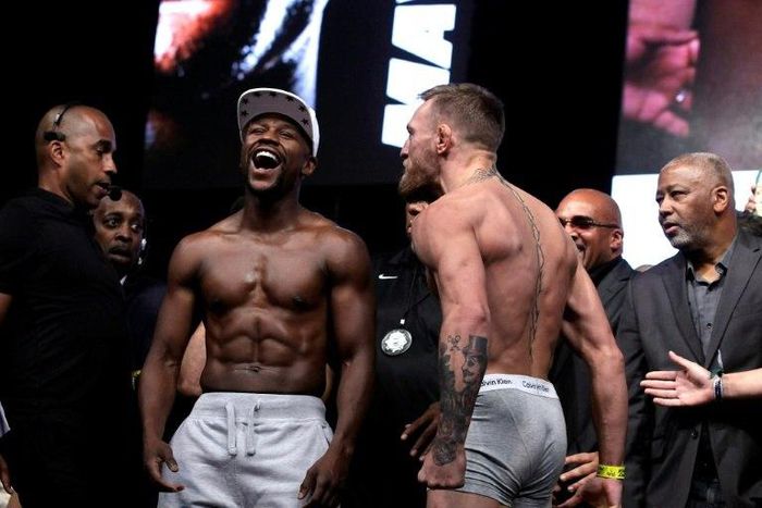 Boxer Floyd Mayweather Jr. (L) and MMA figher Connor Mcgregor pose during their weigh-in in Las Vegas, Nevada