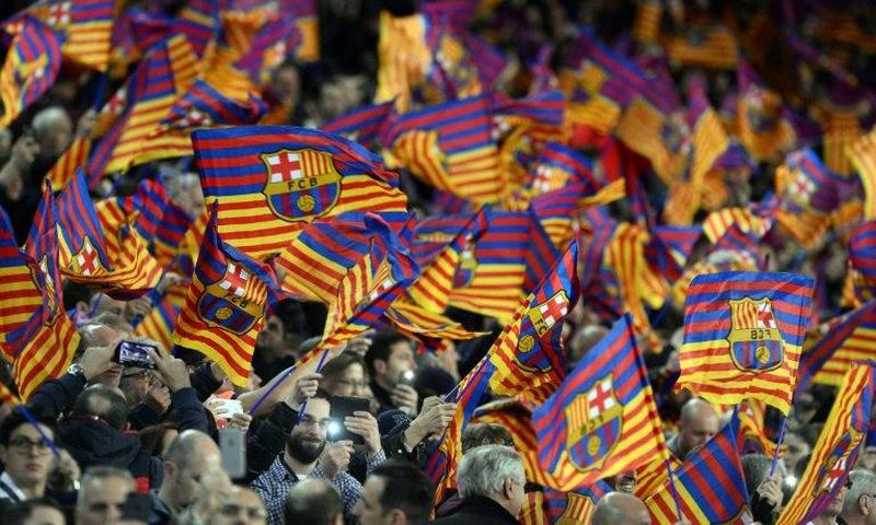Barcelona fans wave flags before the UEFA Champions League round of 16 second leg football match FC Barcelona vs Paris Saint-Germain FC at the Camp Nou stadium in Barcelona on March 8, 2017