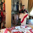 River Plate fanatic Javier Maluf poses with the Argentine's club jersey's at his home in Doha before setting out on his long trek to Madrid