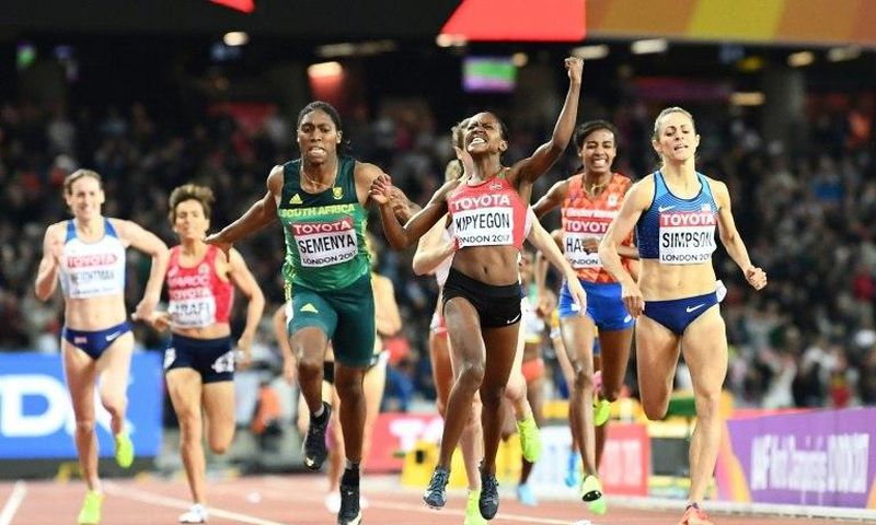 Kenya's Faith Chepngetich Kipyegon celebrates winning as South Africa's Caster Semenya grabs third in the final of the 1,500m event, at the 2017 IAAF World Championships in London on August 7