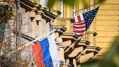 A Russian flag flies next to the US embassy building in Moscow