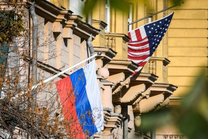 A Russian flag flies next to the US embassy building in Moscow