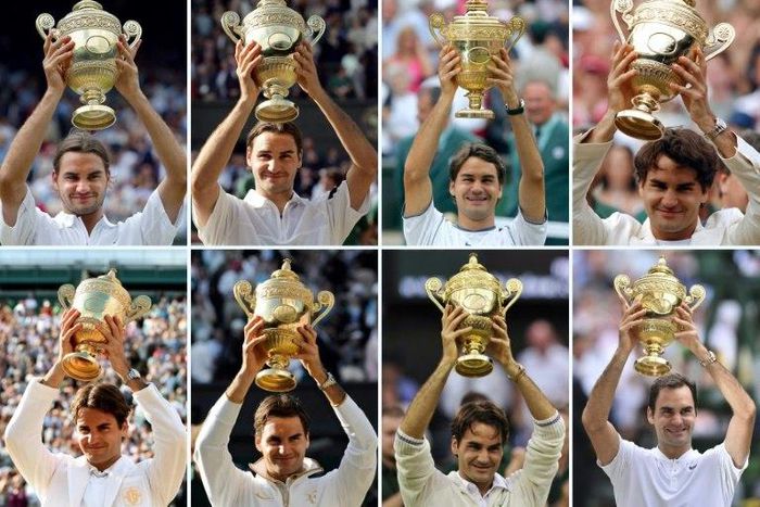 Switzerland’s Roger Federer holds up the Wimbledon Championships trophy after winning each of his eight men's singles titles