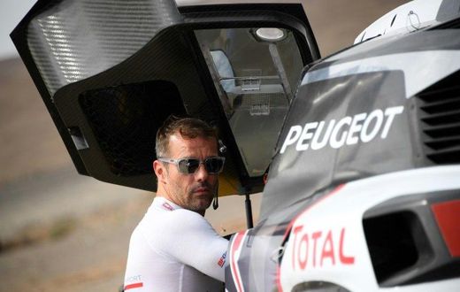 Peugeot's French driver Sebastien Loeb gets ready for a start of the Silk Way 2017 between Urumqi and Hami China, on July 17, 2017