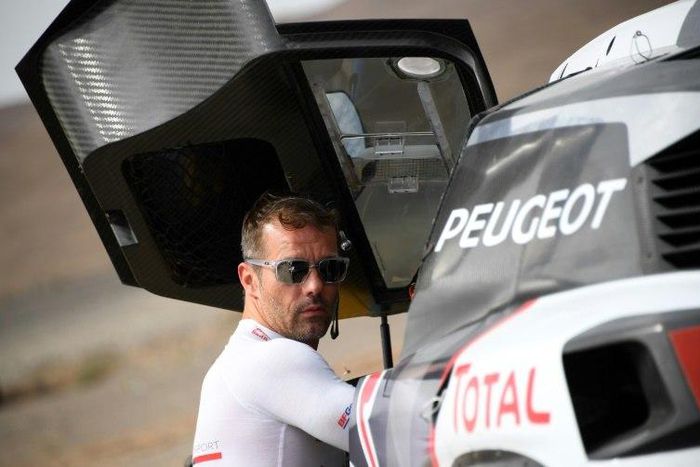 Peugeot's French driver Sebastien Loeb gets ready for a start of the Silk Way 2017 between Urumqi and Hami China, on July 17, 2017