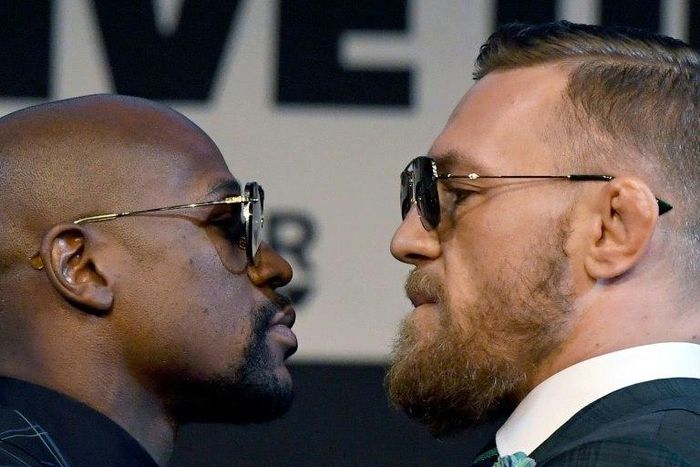 Boxer Floyd Mayweather Jr. (L) and UFC lightweight champion Conor McGregor face off during a news conference at the KA Theatre at MGM Grand Hotel & Casino on August 23, 2017 in Las Vegas, Nevada
