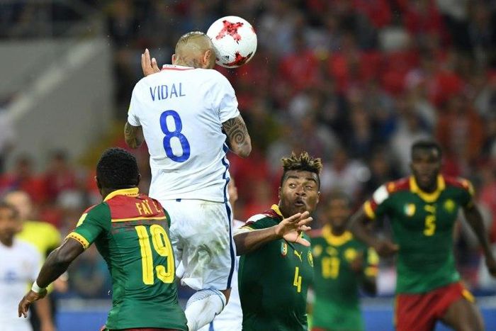 Chile's midfielder Arturo Vidal (C) scores a header against Cameroon on June 18, 2017