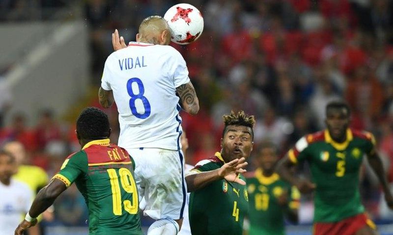 Chile's midfielder Arturo Vidal (C) scores a header against Cameroon on June 18, 2017