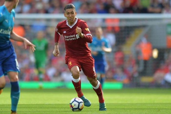 Liverpool's Roberto Firmino runs with the ball during their match against Arsenal in Liverpool, north west England on August 27
