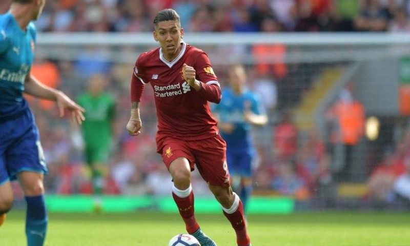 Liverpool's Roberto Firmino runs with the ball during their match against Arsenal in Liverpool, north west England on August 27