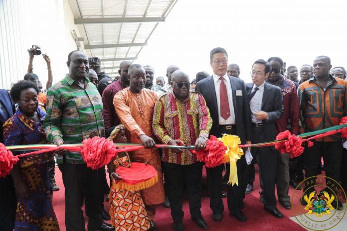 President Akufo-Addo cuts the tape for the commissioning of the diaper making factory